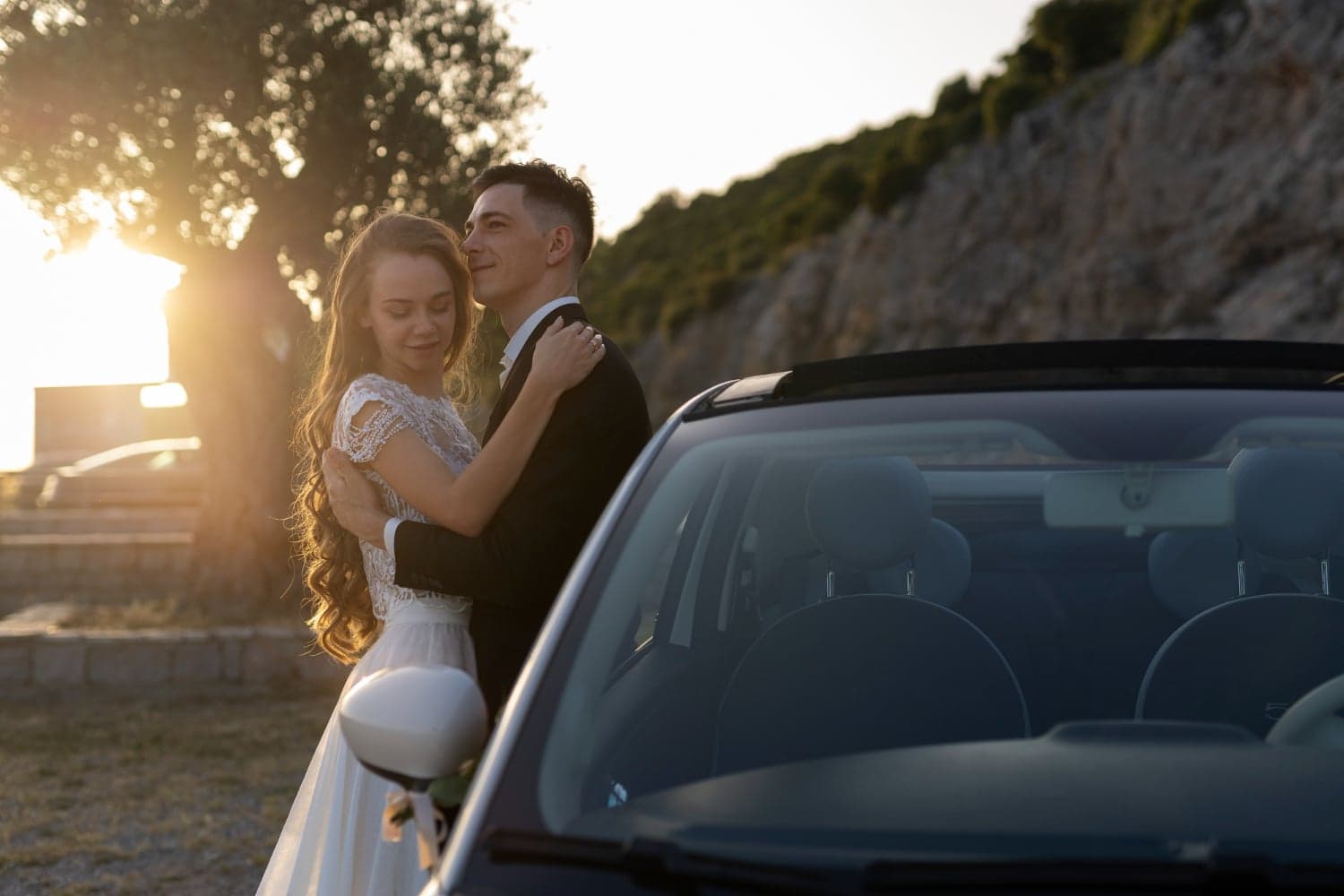 Happy couple beside car